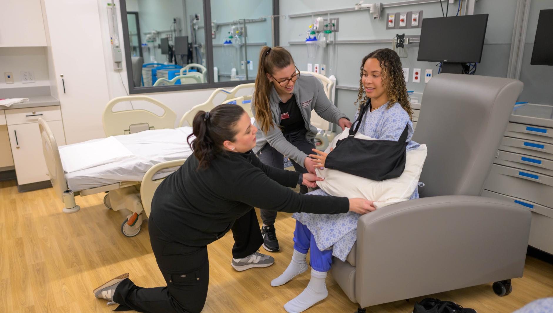 Springfield College occupation therapy students and Assistant Professor of Occupational Therapy Elizabeth Alicea-Torres train inside the simulation lab at the Health Sciences Center on April 23, 2024.