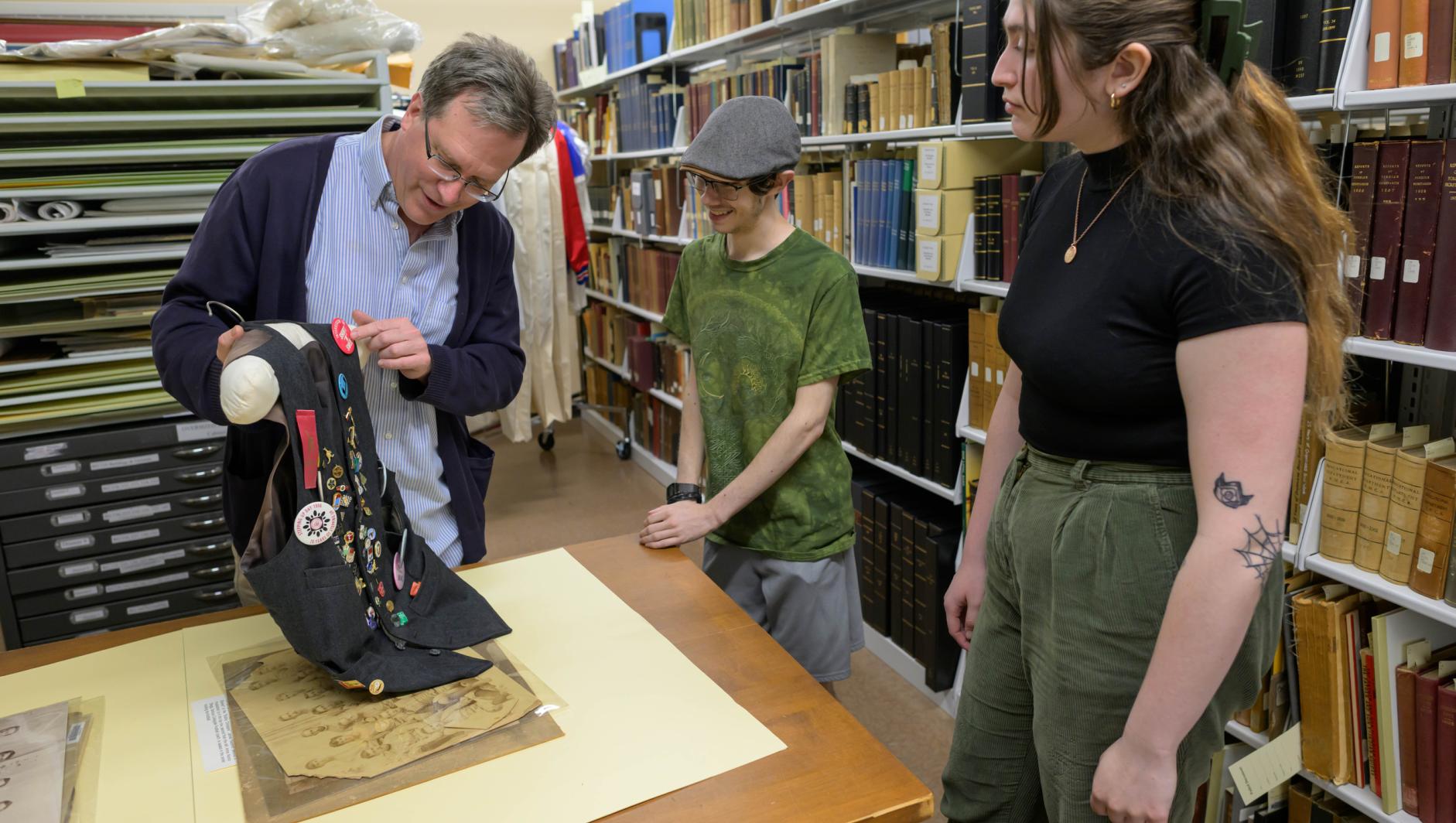 College Archivist Jeffery Moneau works with students at the Springfield College Archives located inside Judd Gymnasia on April 10, 2024.