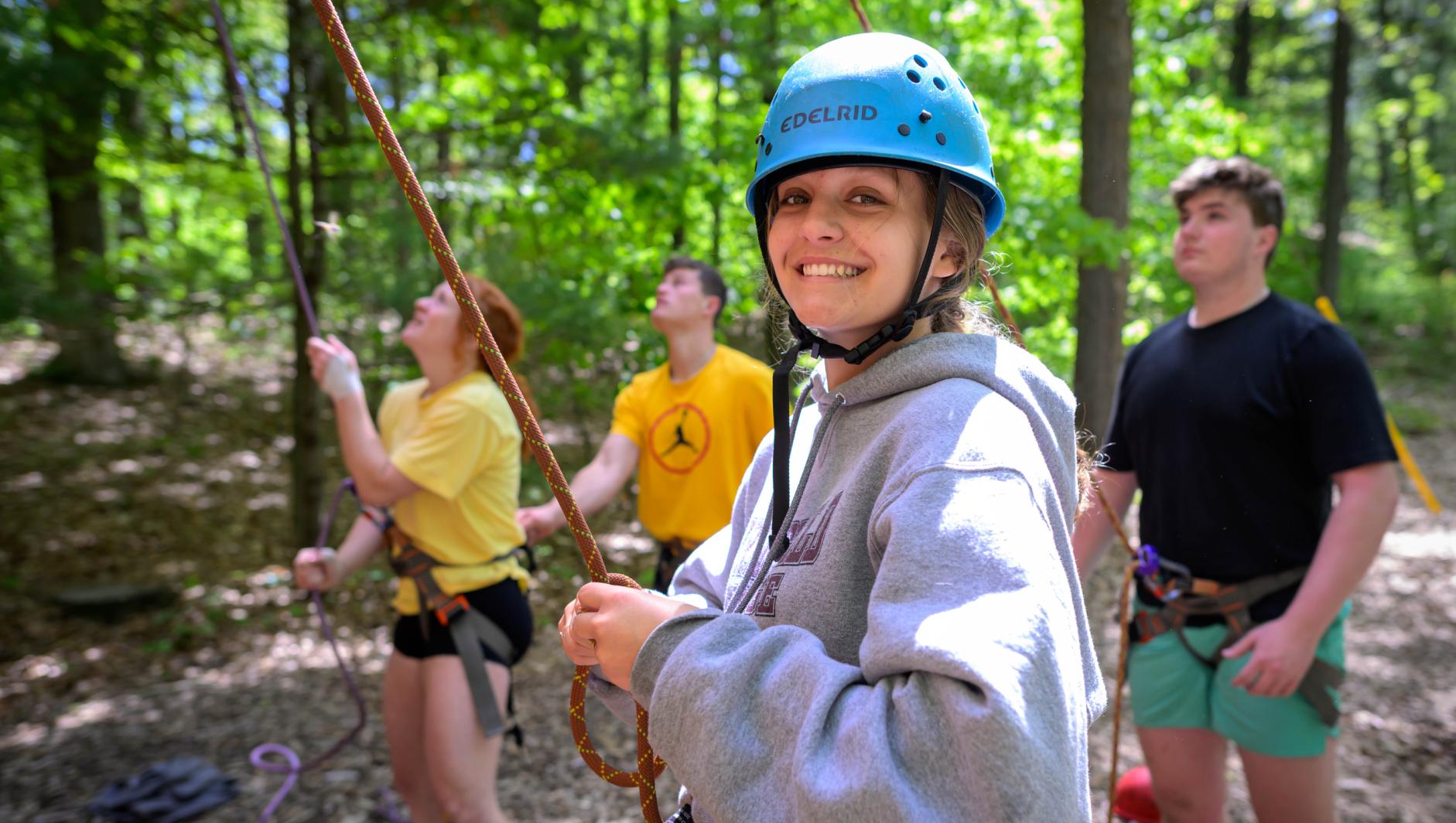 Springfield College students ascend the climbing wall while participating in Outdoor Pursuits at East Campus on Tuesday, May 14, 2024.