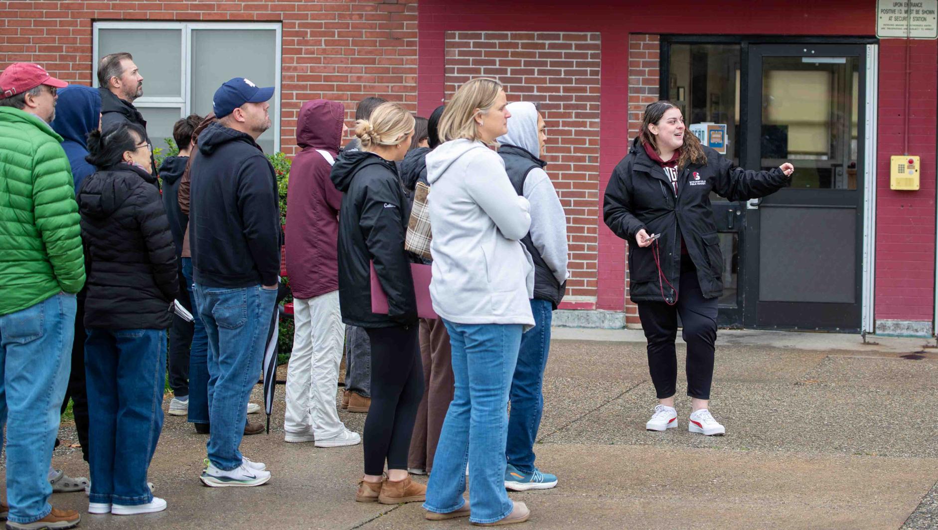 Springfield College student ambassador giving a tour to prospective students and their families.