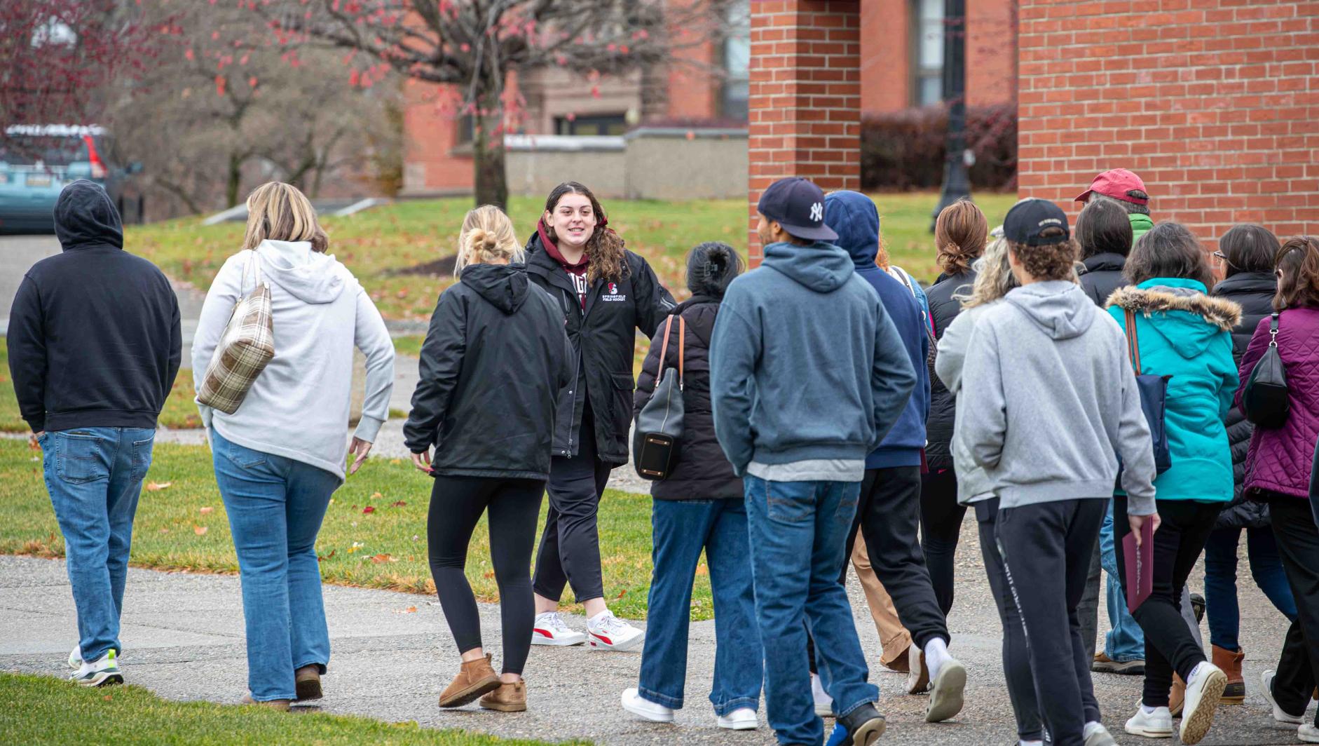 Springfield College student ambassador giving a tour to prospective students and their families.