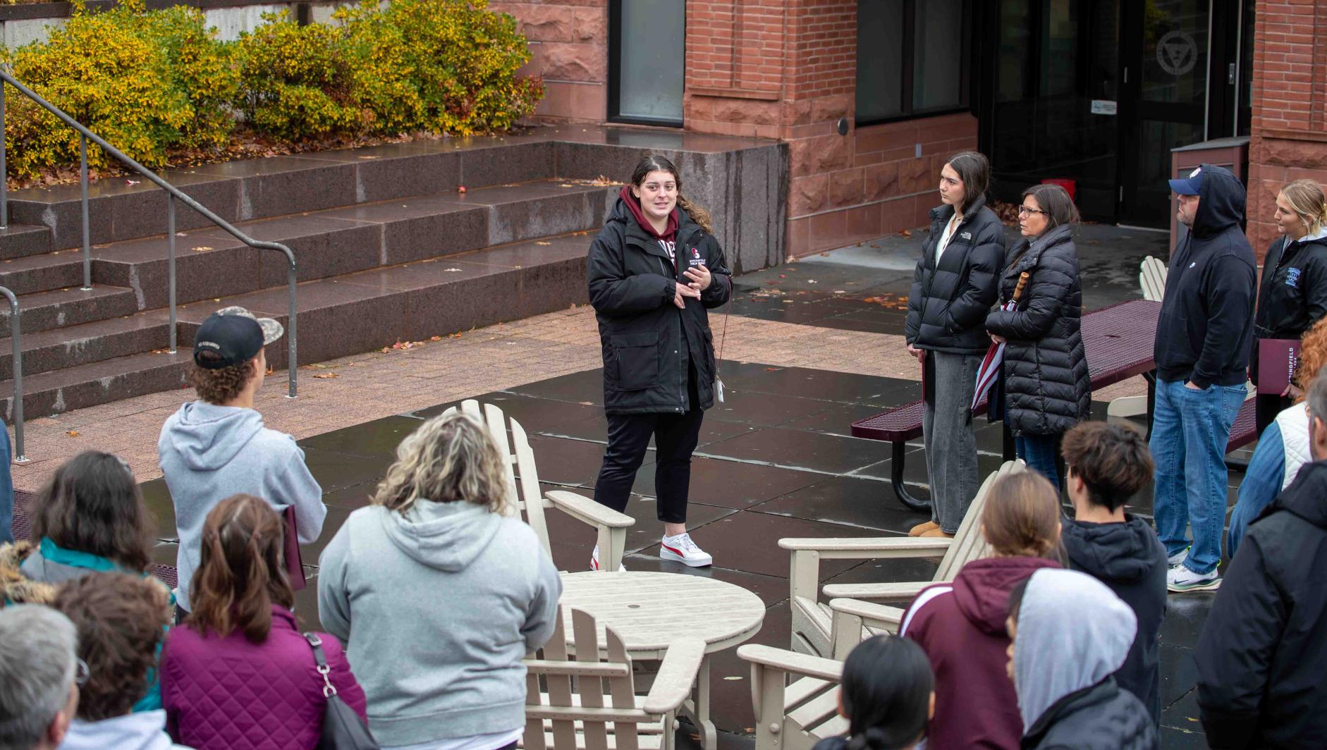 Springfield College student ambassador giving a tour to prospective students and their families.