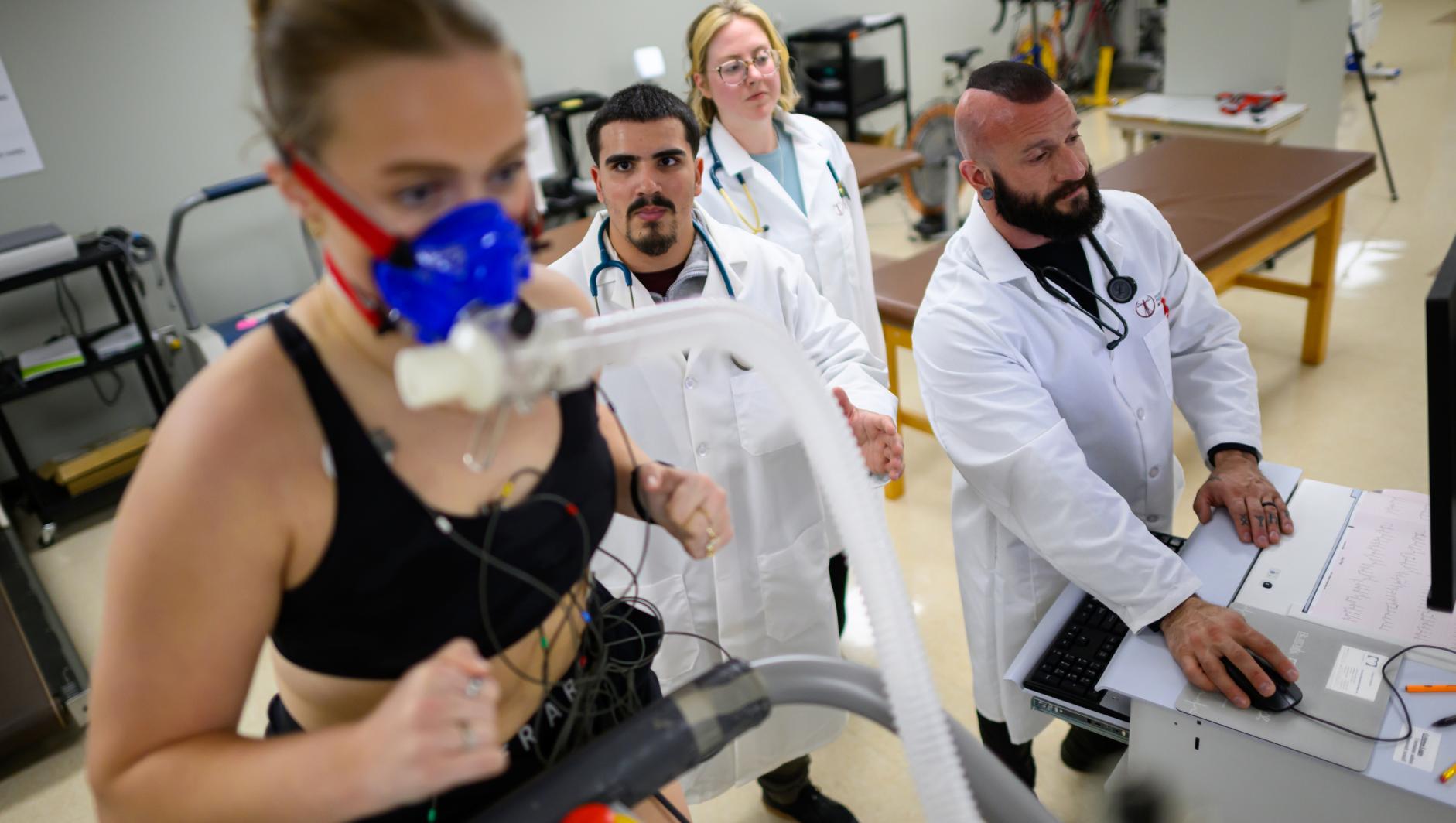 Springfield College graduate students and exercise science faculty perform a VO2 max test to measure the maximum amount of oxygen a student uses during intense exercise inside the Human Performance lab on October 21, 2025.