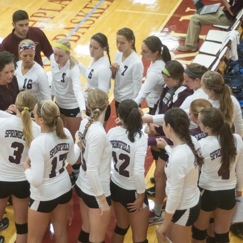 Springfield College women's volleyball team in a huddle