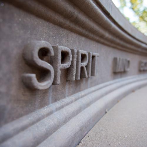 The word "Spirit" engraved onto a bench on the Springfield College campus.
