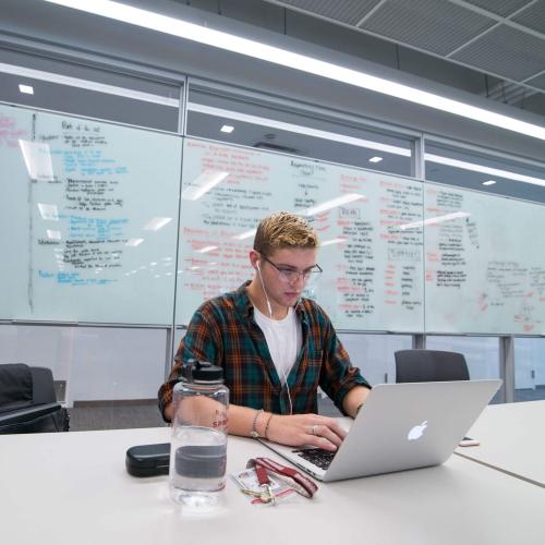 A student does work on his laptop in the Learning Commons.