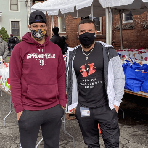 Two students stand at a turkey drive 