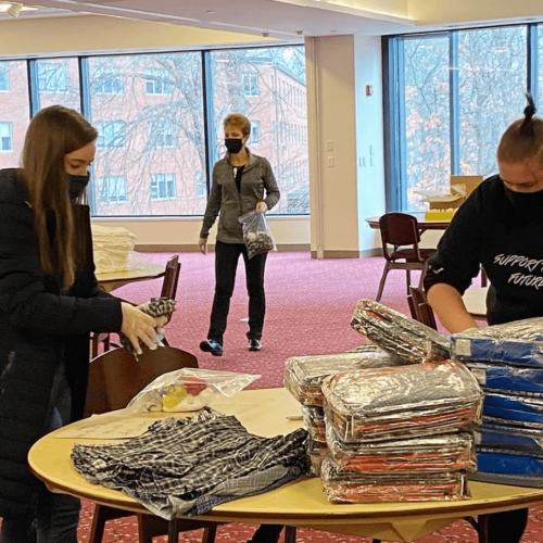 Students in the union stuff bags for Friends of the Homeless