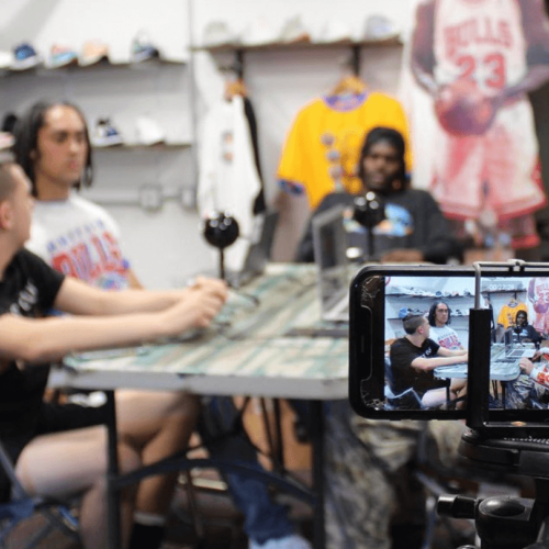 A video records students hosting a podcast at a table