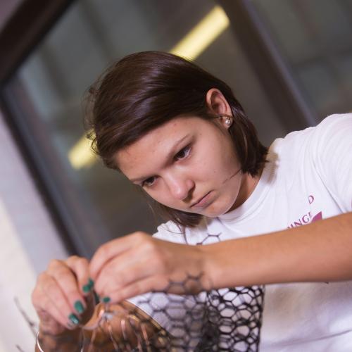 Female student makes a wire sculpture