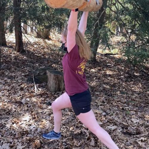 Cassidy Thomas lifts a log over her head
