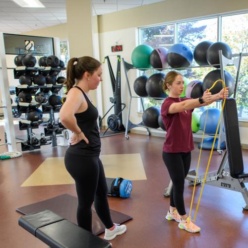 Springfield College exercise science student Kathleen Katie Beliveau works out with a classmate