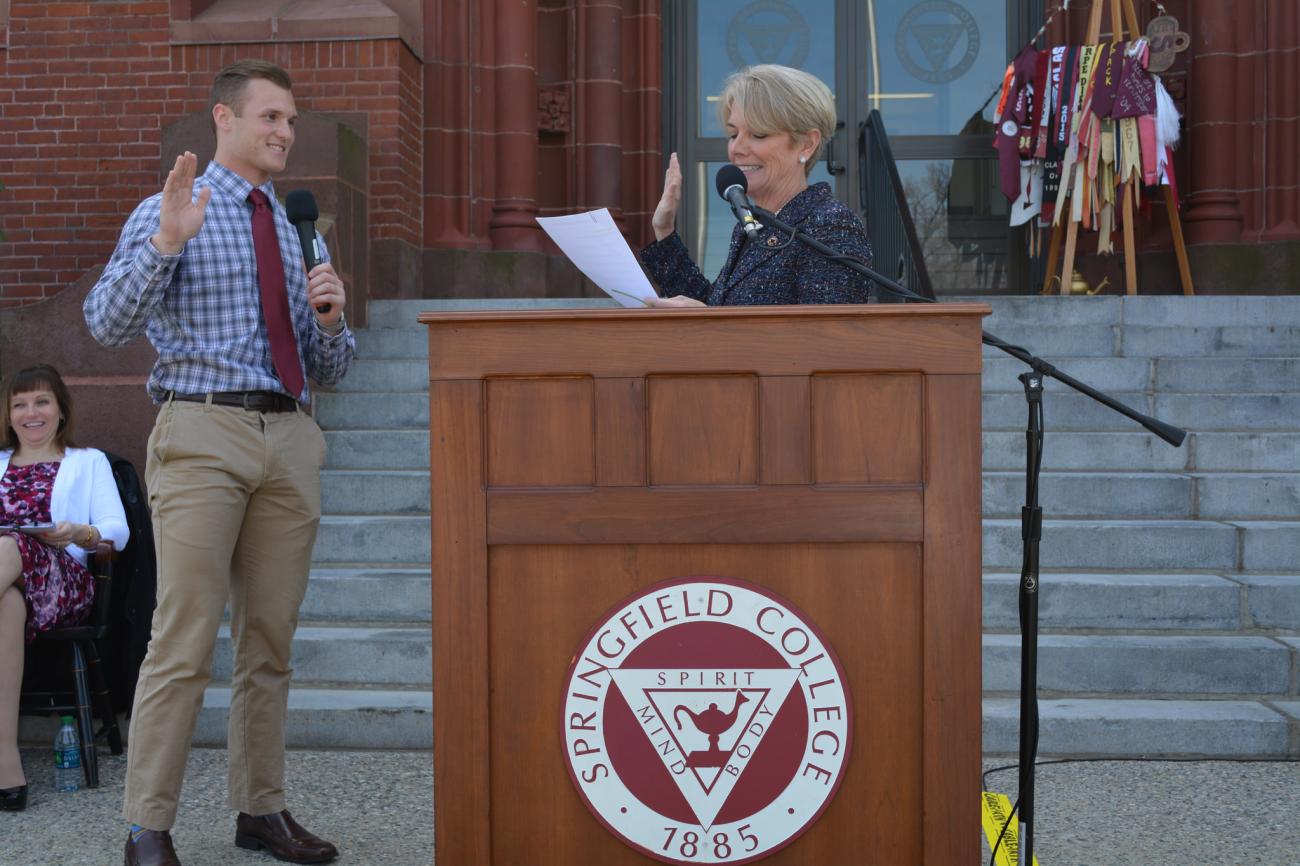 Student Trustee Troy Ward sworn in by President Mary-Beth Cooper.