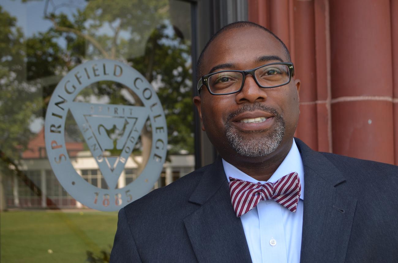 Calvin Hill stands infront of campus building