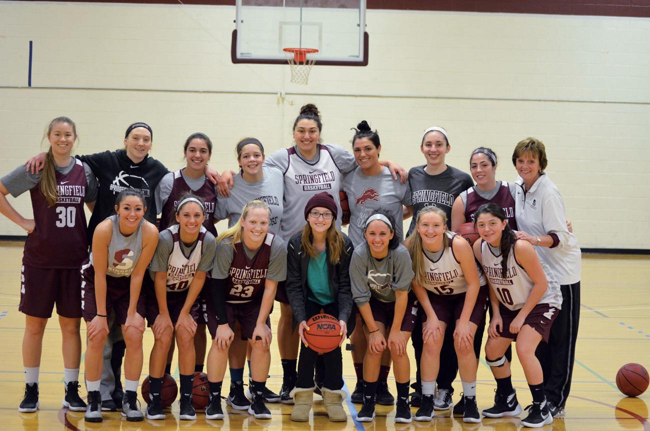 Team IMPACT teammate poses for a photo with the Springfield College Women's Basketball team