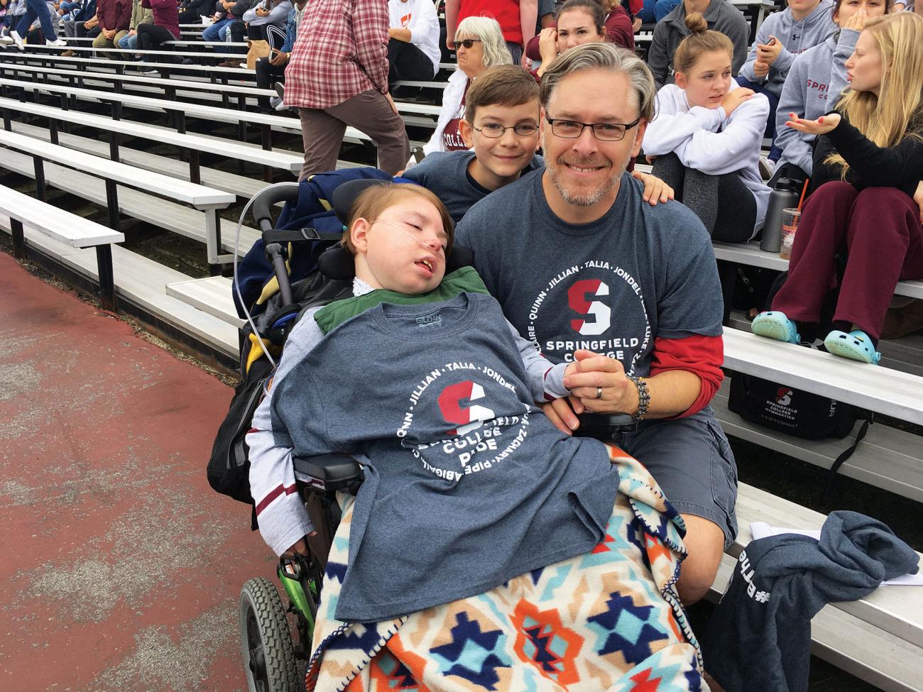 Team IMPACT participant and Men's Gymnastics teammate Zachary LaBroad and his father Eric Volz Benoit attend a Pride football game.