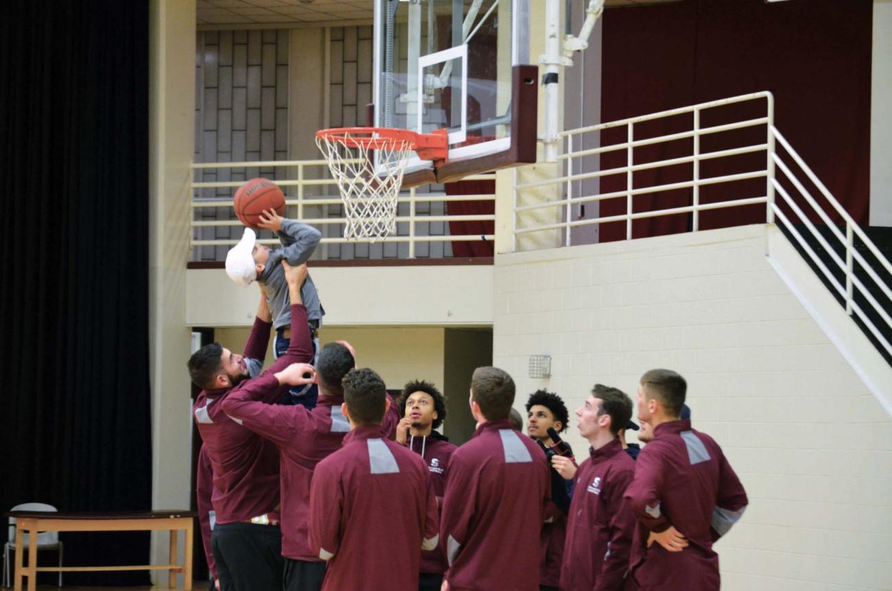 Jondel Rivera Ruiz gets a hand making a basket from the Springfield College Men's Basketball