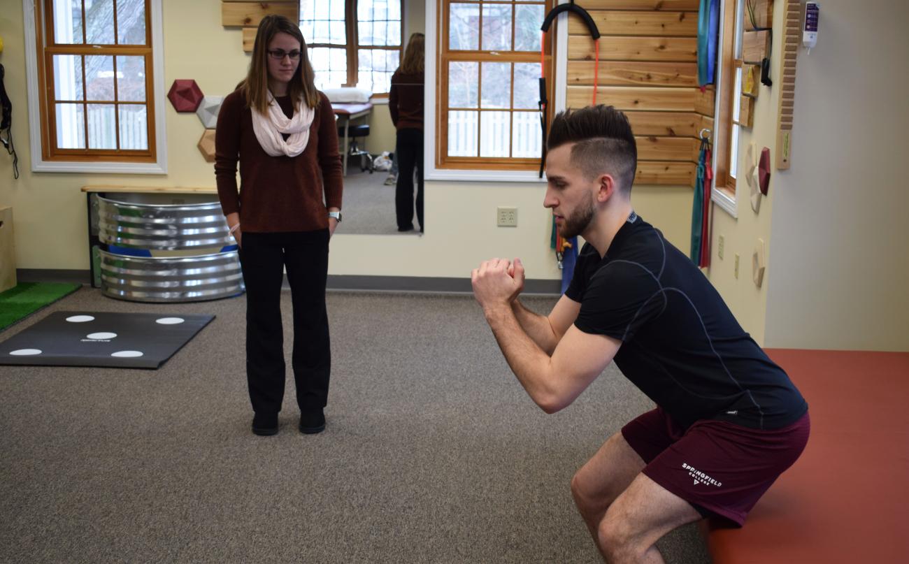 At left, Springfield College 2018 graduate of the physical therapy program Abby Mulligan works with a patient at the clinic on the campus.