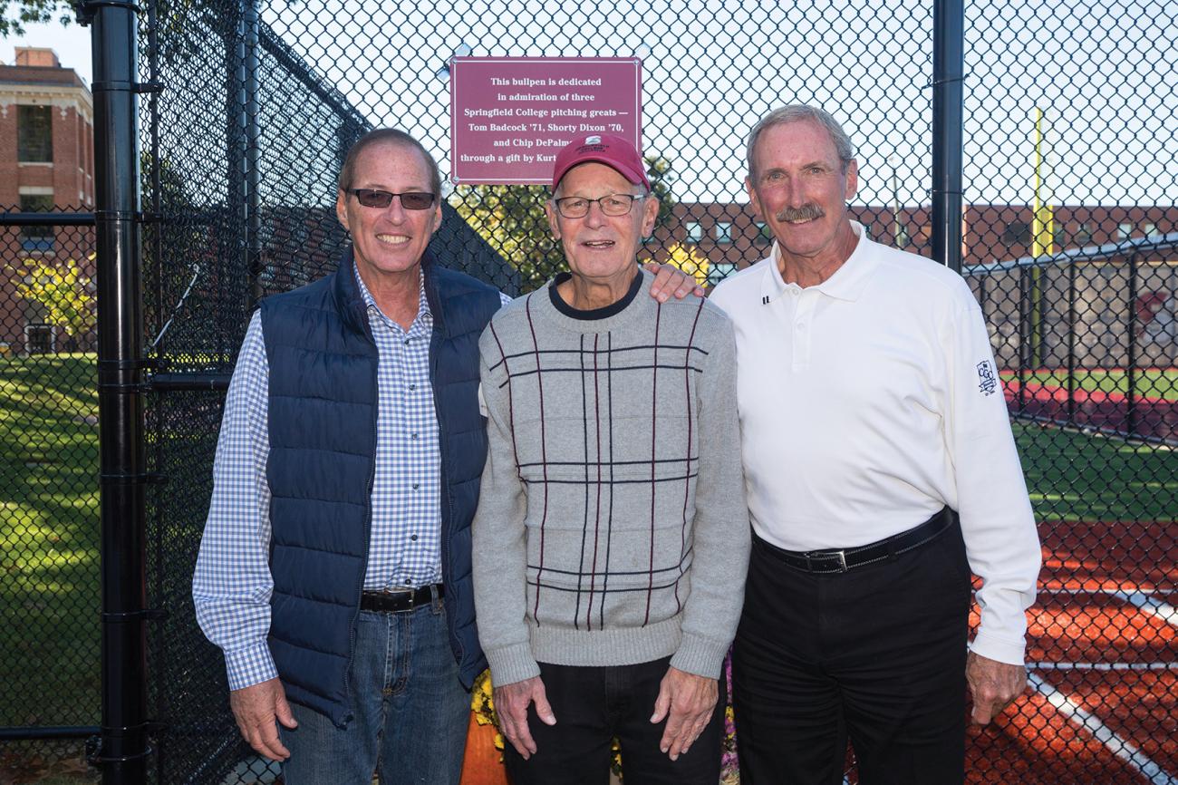 Chip DePalma ’71, from left, Shorty Dixon ’70, G’77, and Tom Badcock ’71, in front of the home bullpen dedicated in their honor during the baseball alumni reunion in October.