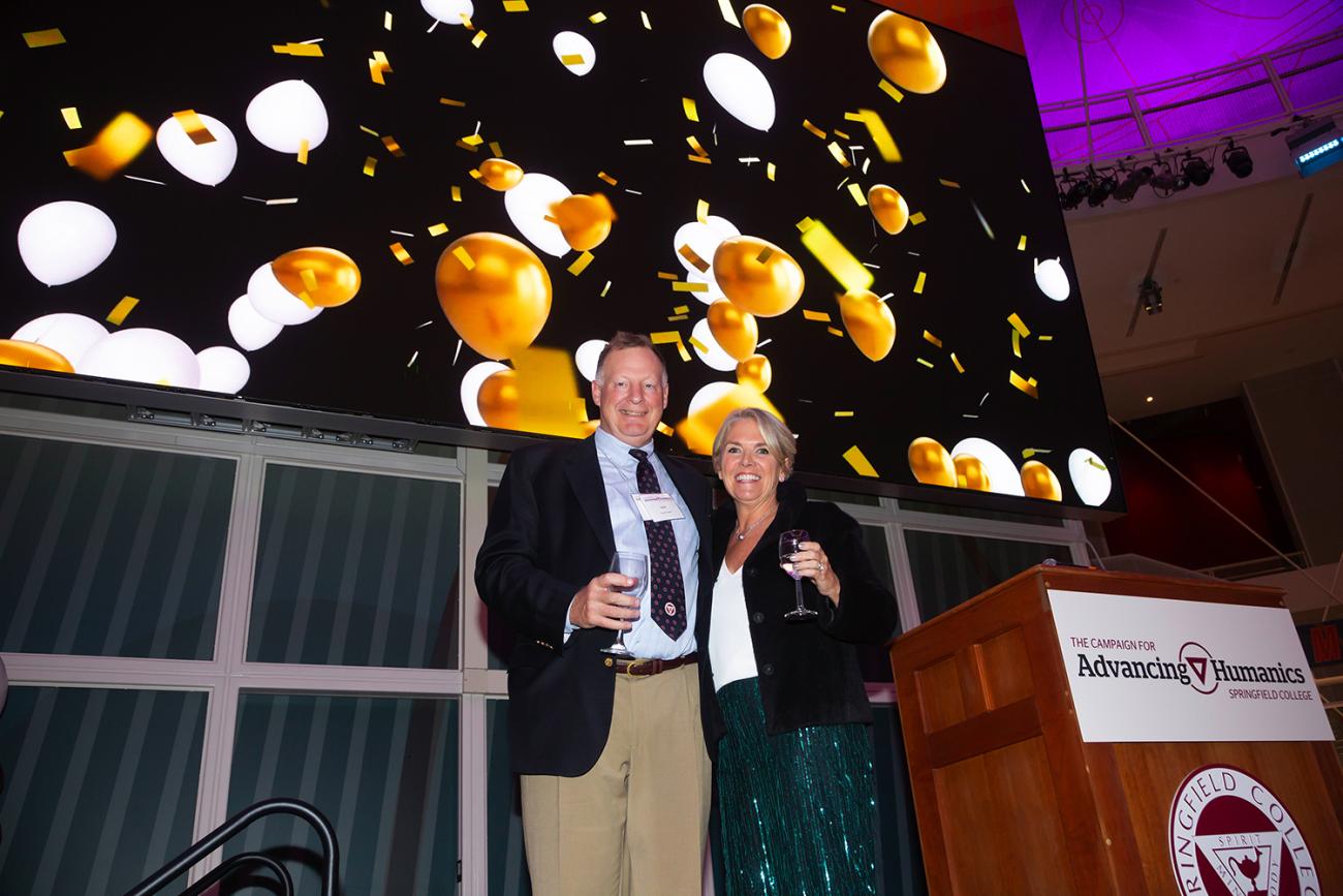 At right, Springfield College President Mary-Beth Cooper and David Cooper provide a toast to attendees at the Advancing Humanics Campaign Launch event.