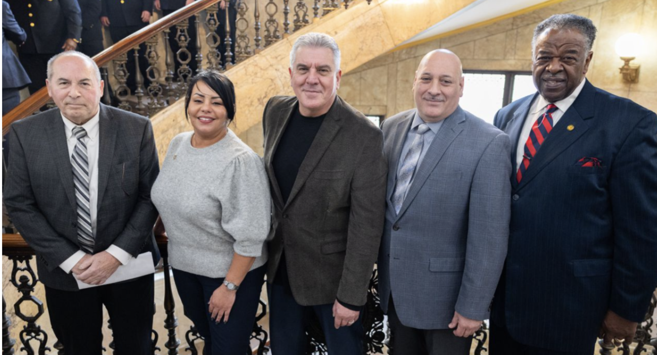 Springfield College Assistant Professor of Criminal Justice Gary Berte, center, was sworn in as a member of the Springfield Board of Police Commission by City Clerk Gladys Oyol on March 1, 2022.