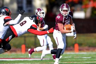 A football player carries the ball during a game