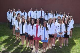 The Springfield College Physician Assistant Program hosted the annual White Coat Ceremony on Stagg Field on Friday, May 14, 2021. The White Coat Ceremony commemorates the formal presentation of the white lab coat for physician assistant students as they begin working with patients in hospitals.