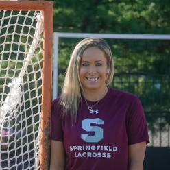 Photo of Jenn Thomas by a lacrosse net