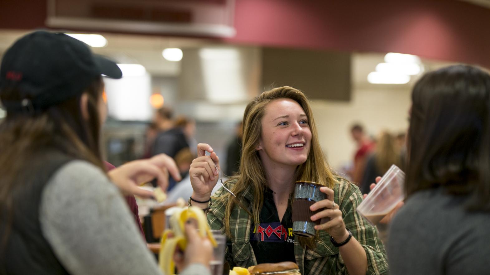 A student eats lunch in Cheney Hall, the College's dining facility