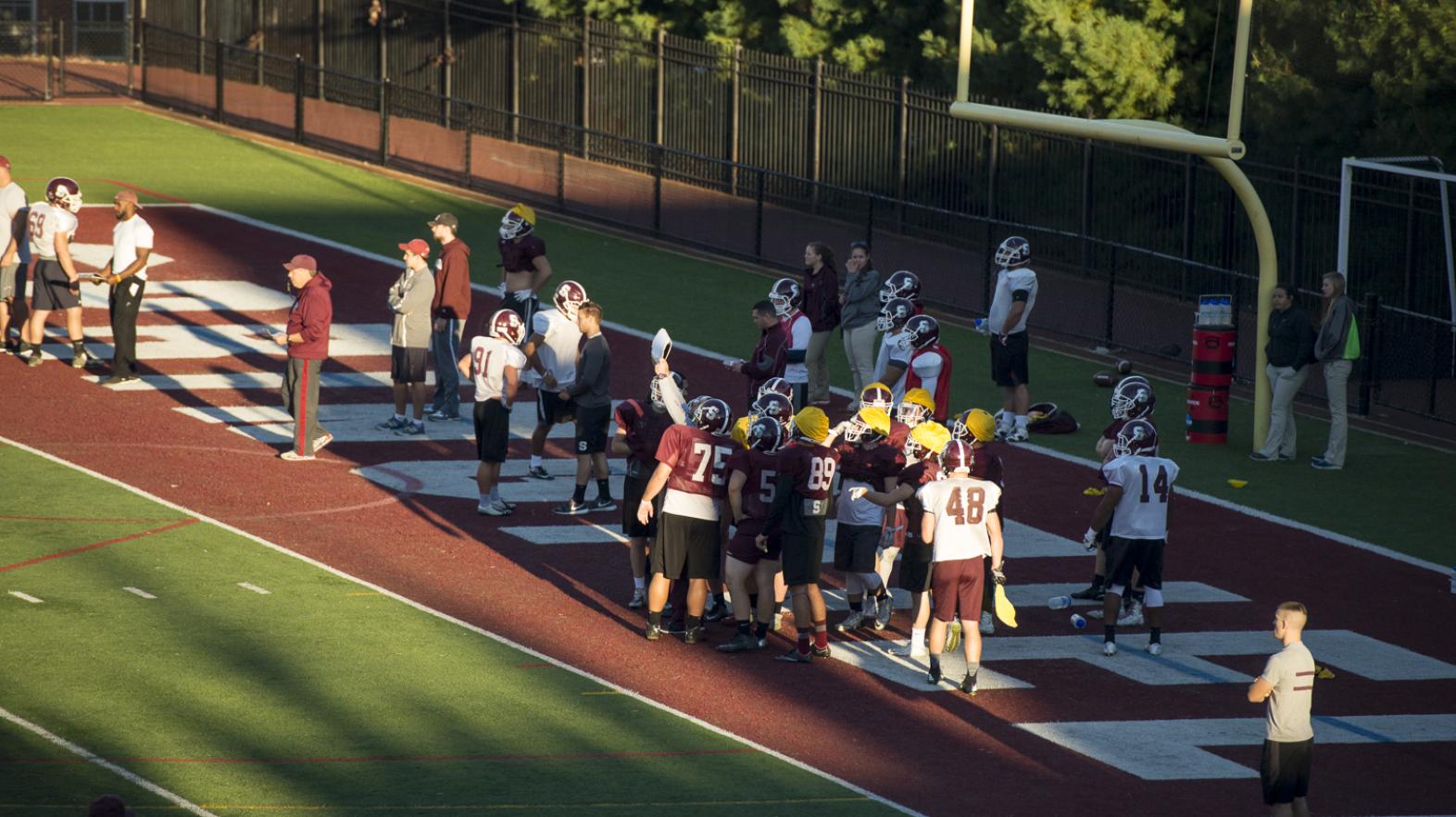 Men's football team practices on Stagg Field