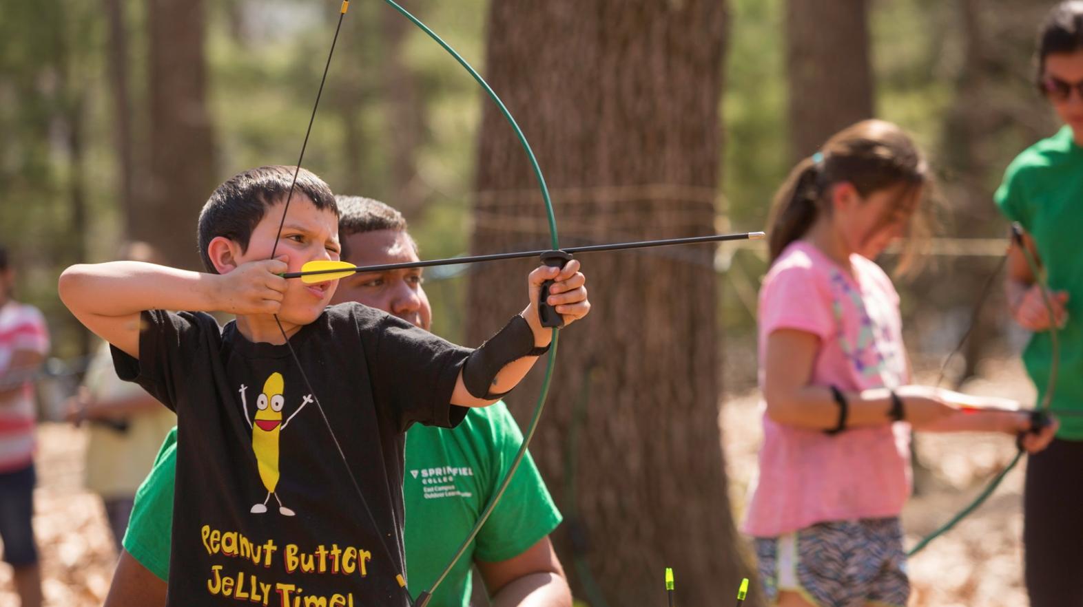 Young boy practices archery as part of Spring Explorers at East Campus