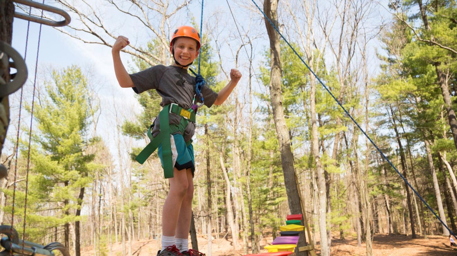 Young child on the challenge course at East Campus