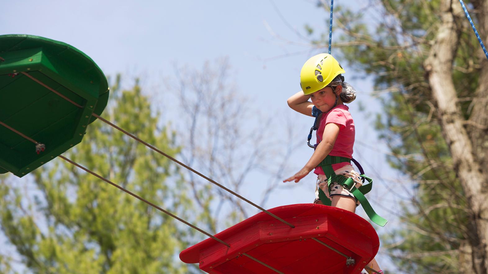 Young girl focusing on the challenge course at East Campus