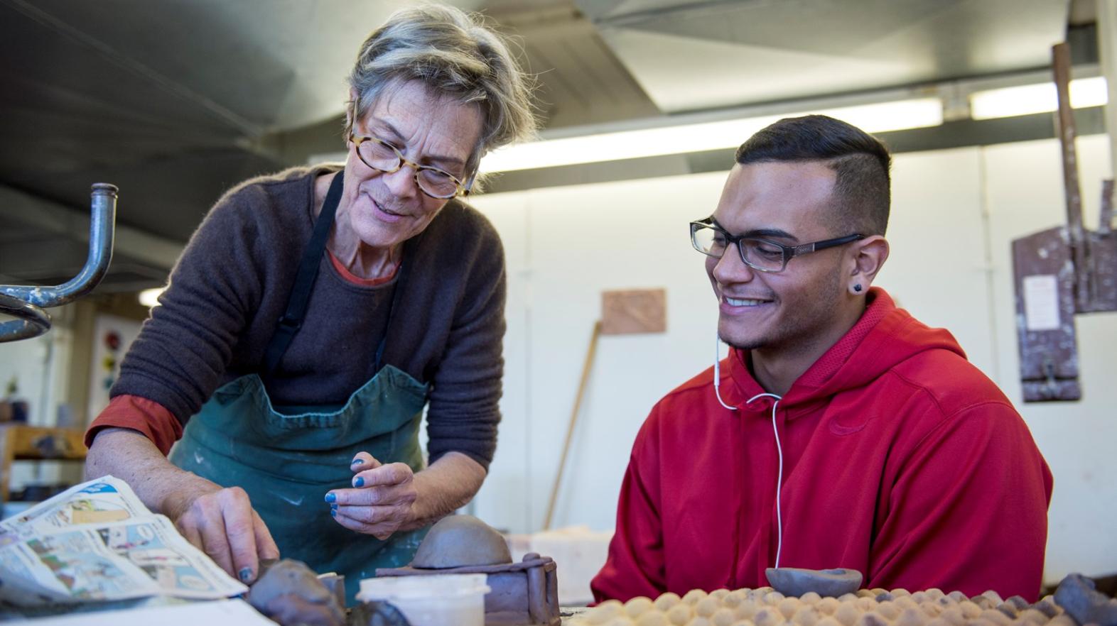 Professor Holly Murray works with an art student in the classroom