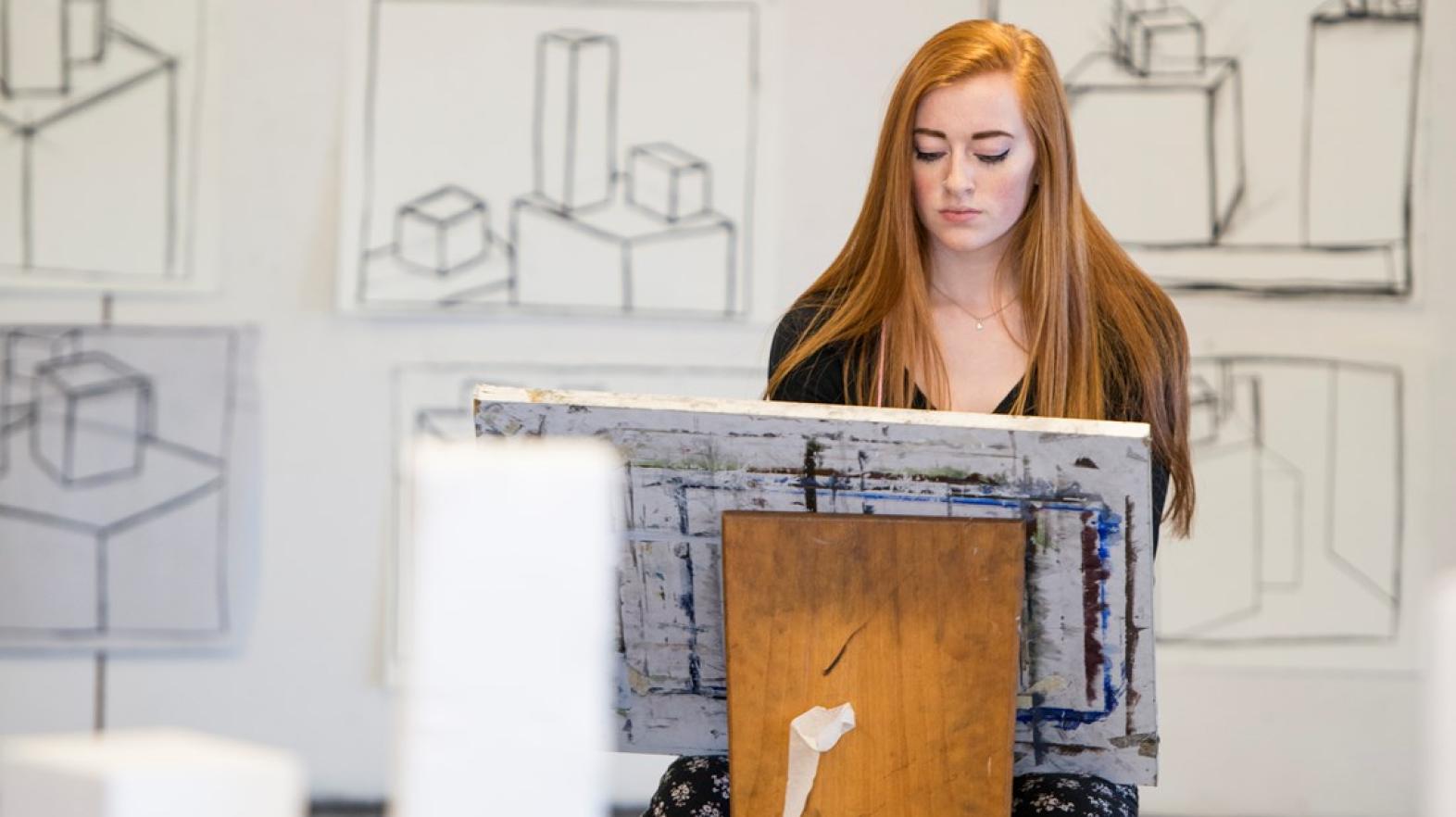 Young woman uses art studio space to create art