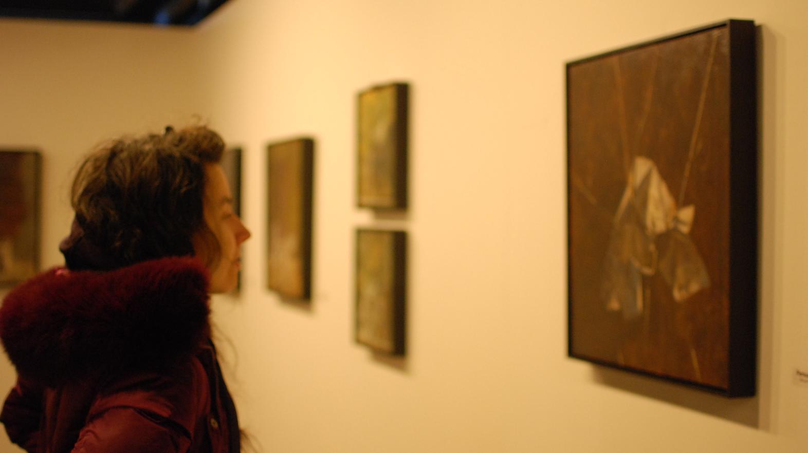 Student admires art in the William Blizard Gallery