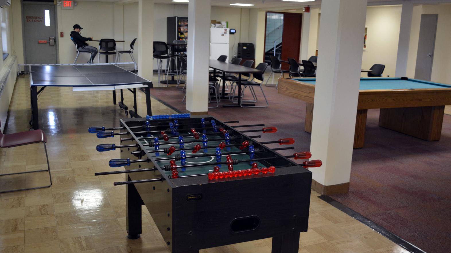 A foosball and ping pong table are included in the common area of Massasoit residence hall.