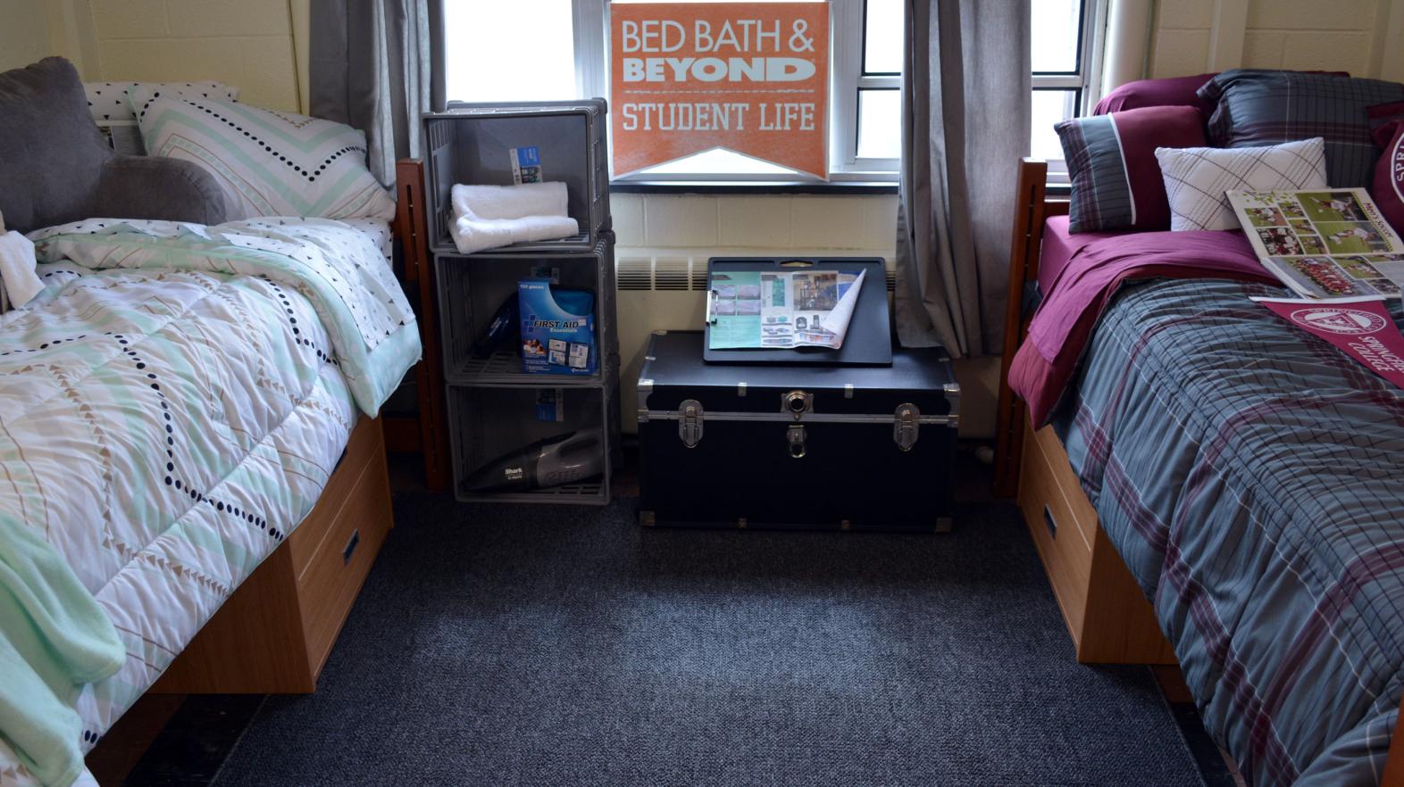 A room in Massasoit Hall with two beds and desk area for students.