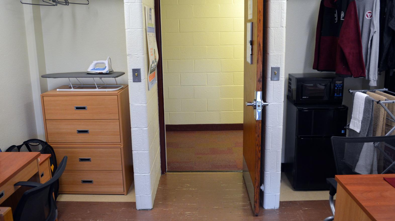 Massasoit Hall room with an open door and closet to show the community feel created in the residence hall.