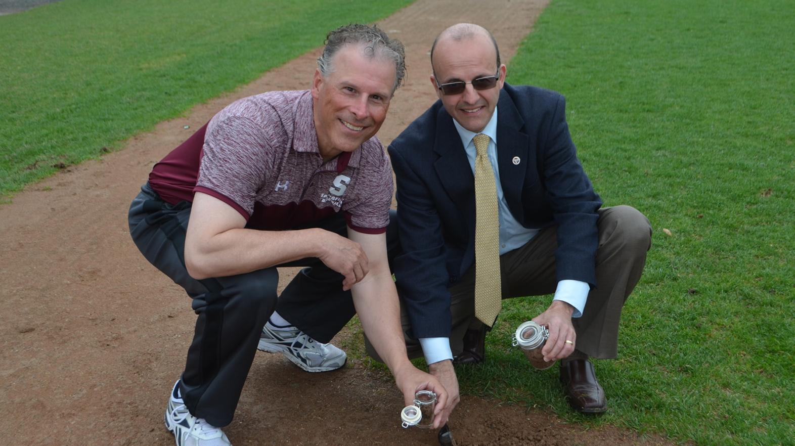 Dr. Poisson and Coach Simeone take a little bit of Berry-Alllen dirt with them before construction begins. 