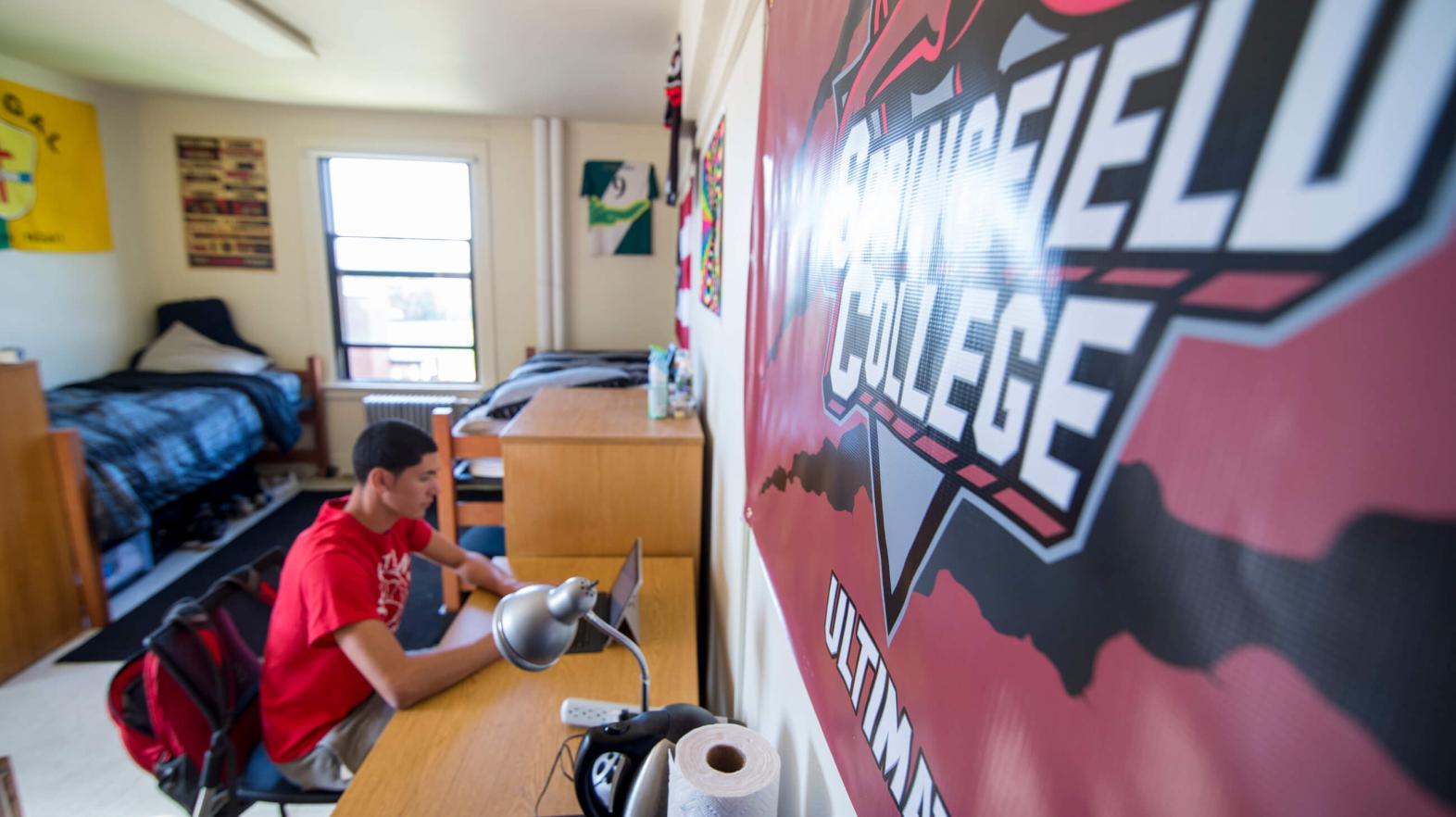 A student sits on his computer in one the residence halls.