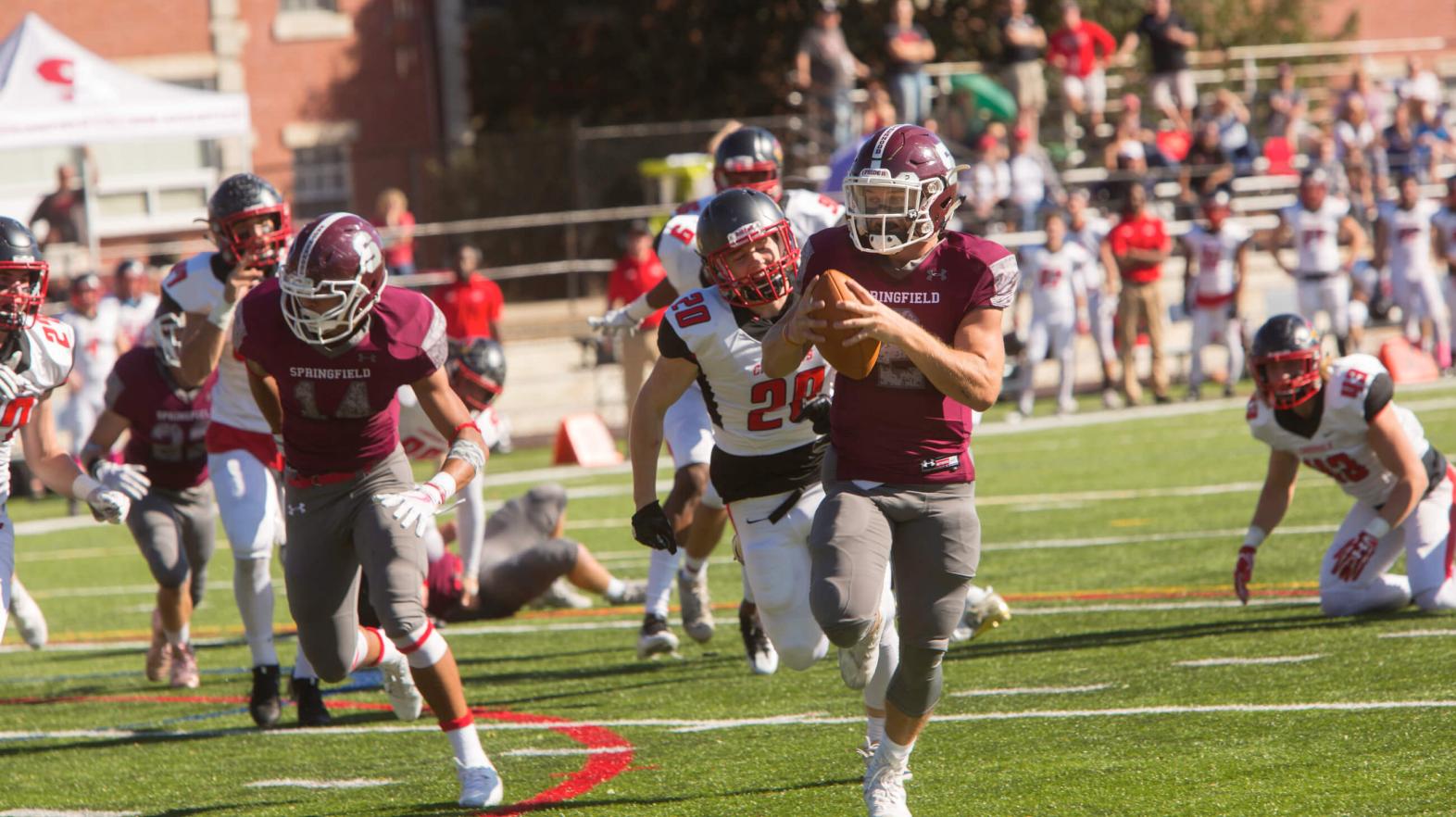 Football team playing on Stagg Field. 