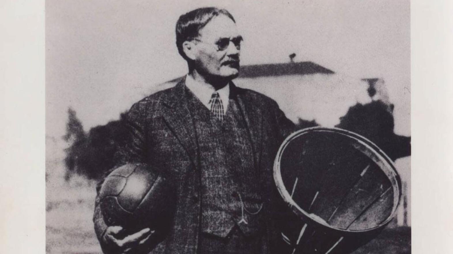 James Naismith holding ball and basket