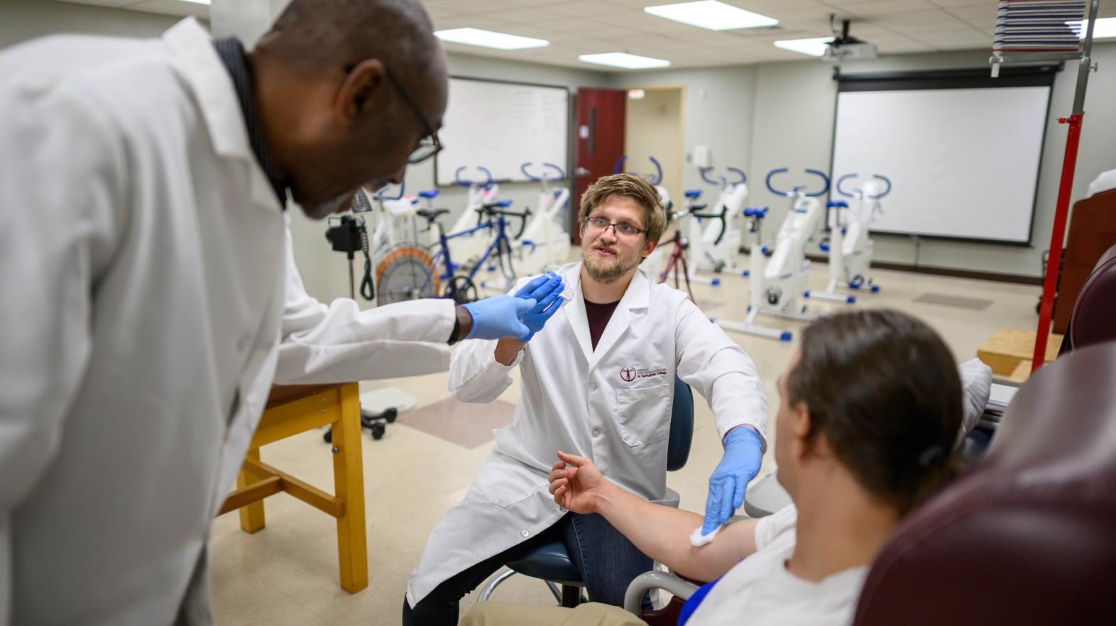 Springfield College graduate and doctoral students draw blood in the Springfield College Human Performance Lab on July 23, 2024.