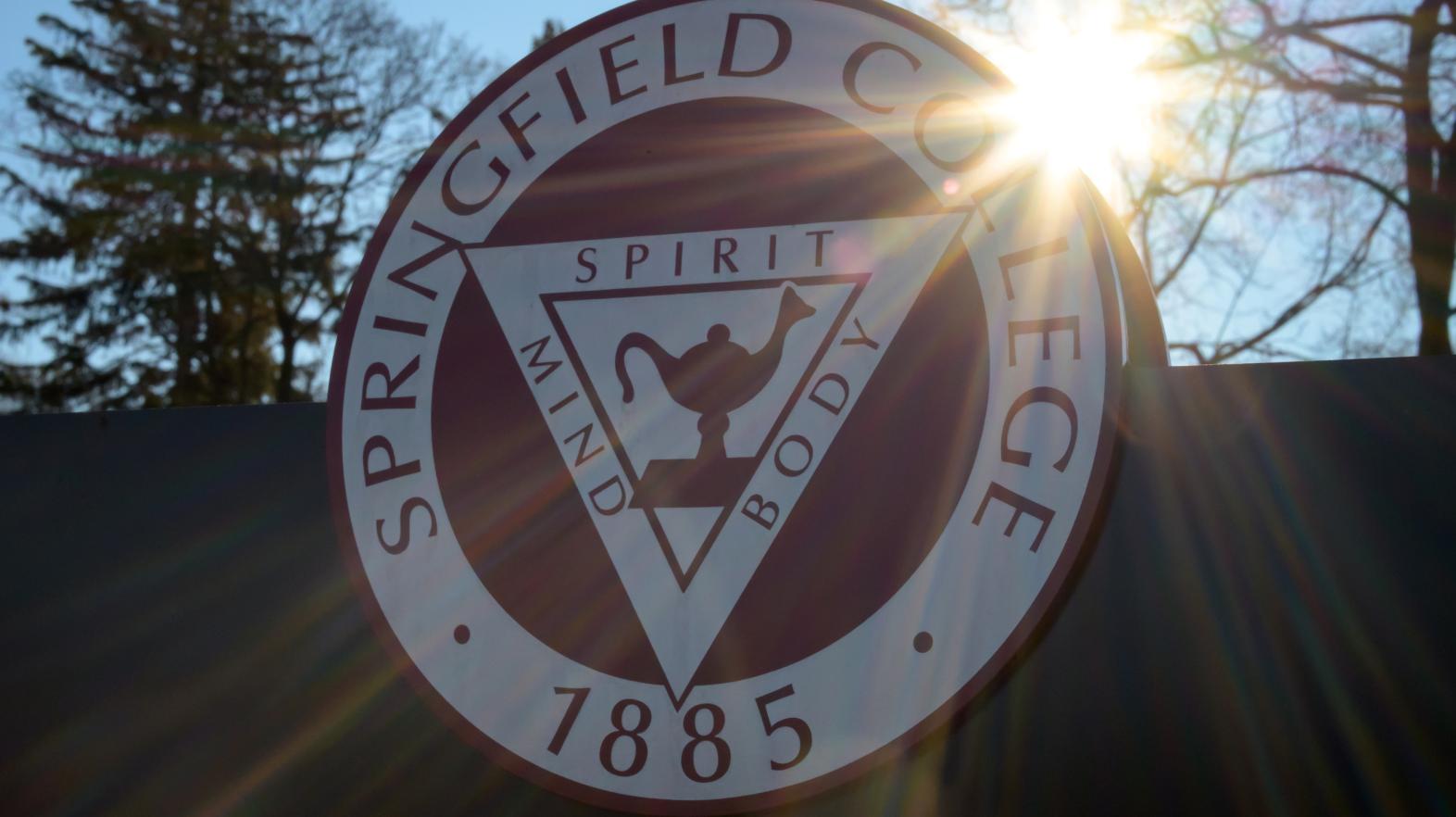 The sun shines from behind a Springfield College seal on January 8, 2026.
