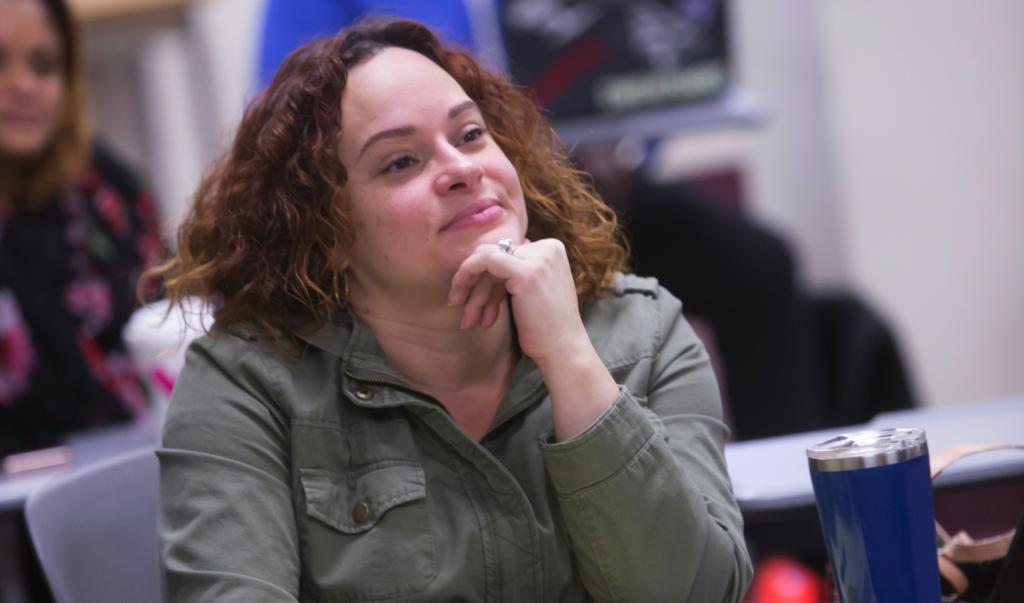 Student listening in class while sitting at desk