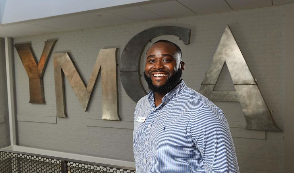 Male student in front of YMCA sign