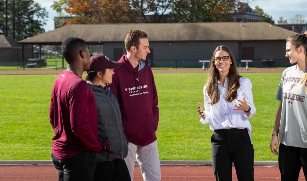 Springfield College Assistant Professor of Exercise Science Kathleen Mellano works with students on the Blake Track 