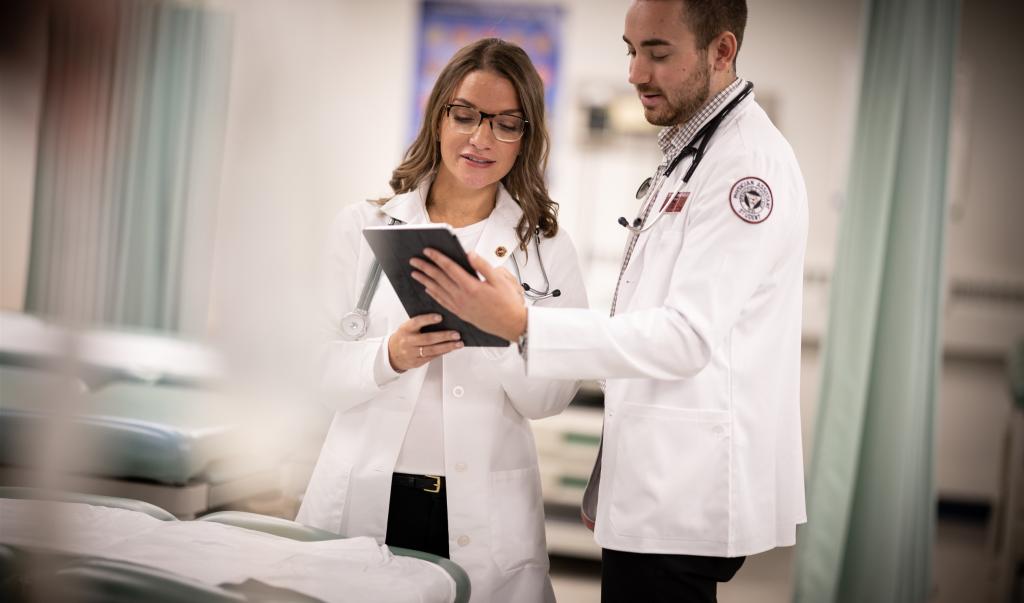 Physician Assistant lab or clinic (PA). Graduate Students Practicing on a Patient.