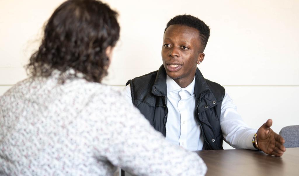 Clinical mental health counseling students having a discussion at a table